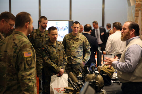 U.S. Army and German Army signal officers receive a briefing from a vendor at the USAG Wiesbaden Tech Expo Feb. 7, 2017 at Clay Kaserne. (U.S. Army photo by Staff Sgt. Brian M. Cline)